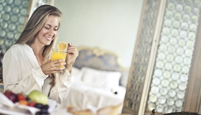cheerful-woman-enjoying-breakfast-in-morning-3771067.jpg